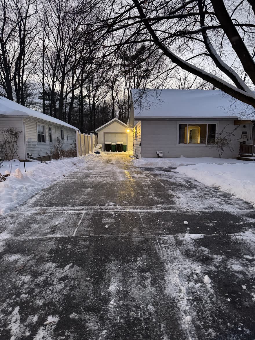 Long driveway plowed all the way back to a detached garage, snowbanks pushed neatly to both sides